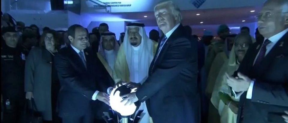 U.S. President Donald Trump places his hands on a glowing orb as he tours with other leaders the Global Center for Combatting Extremist Ideology in Riyadh