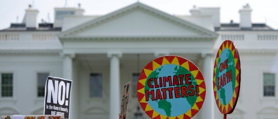 FILE PHOTO: Protesters carry signs during the Peoples Climate March at the White House in Washington