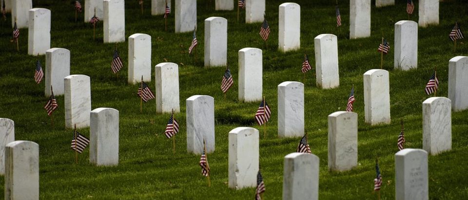 (Arlington National Cemetery - May 22, 2008) -- Flags stand vigil at gravesites in Arlington National Cemetary. The 3rd U.S. Infantry Regiment (The Old Guard) began their rounds to place a small American flag into the ground in front of every grave marker at Arlington National Cemetery for the upcoming Memorial Day observance. (Photo by Adam Skoczylas).