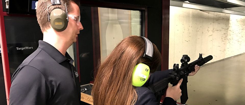 Lee Thompson, the product design director at Daniel Defense, shows Rachel Harris of The Herald Group how to shoot a suppressed rifle at Elite Shooting Sports in Manassas, Va. on May 22, 2017. (PHOTO: Will Racke/TheDCNF)