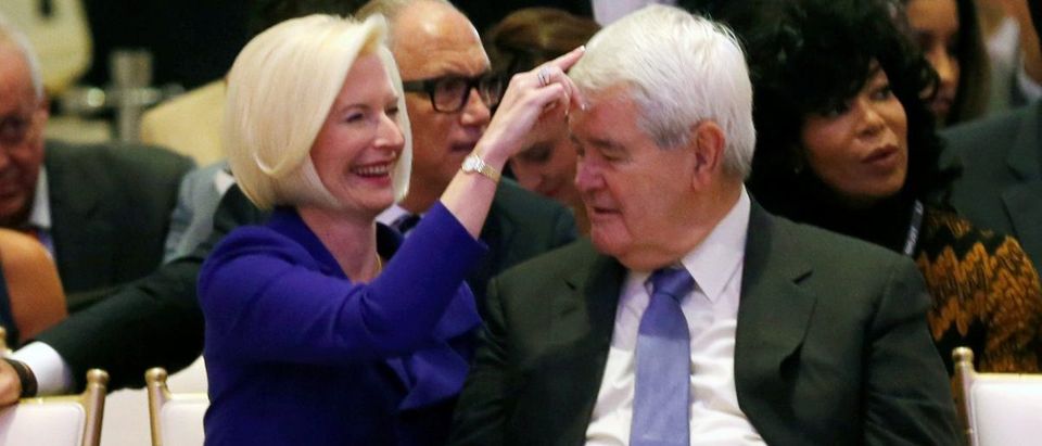 Callista Gingrich fixes the hair of her husband Newt Gingrich at an official ribbon cutting ceremony at Trump International Hotel in Washington