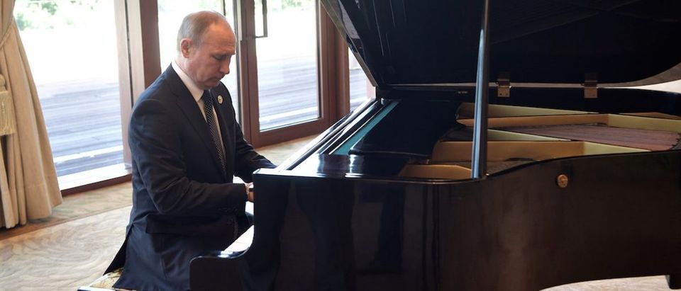 Russian President Vladimir Putin plays piano before meeting Chinese leader Xi Jinping on the first day of the Belt and Road Forum in Beijing