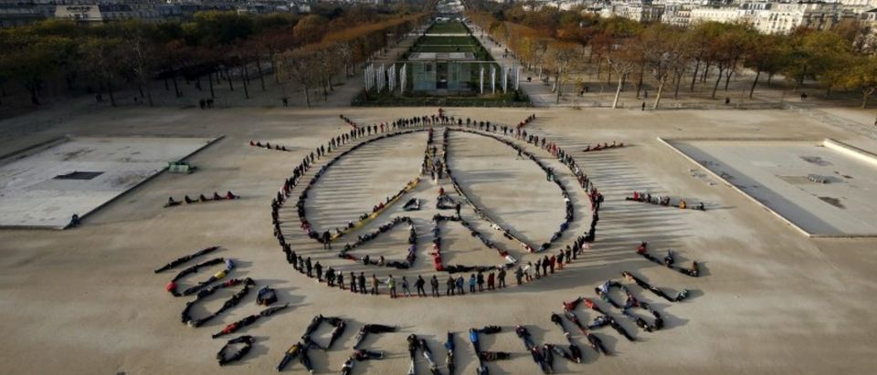 Hundreds of environmentalists arrange their bodies to form a message of hope and peace in front of the Eiffel Tower in Paris, France, December 6, 2015, as the World Climate Change Conference 2015 (COP21) continues at Le Bourget near the French capital. (Photo: REUTERS/Benoit Tessier/File Photo)