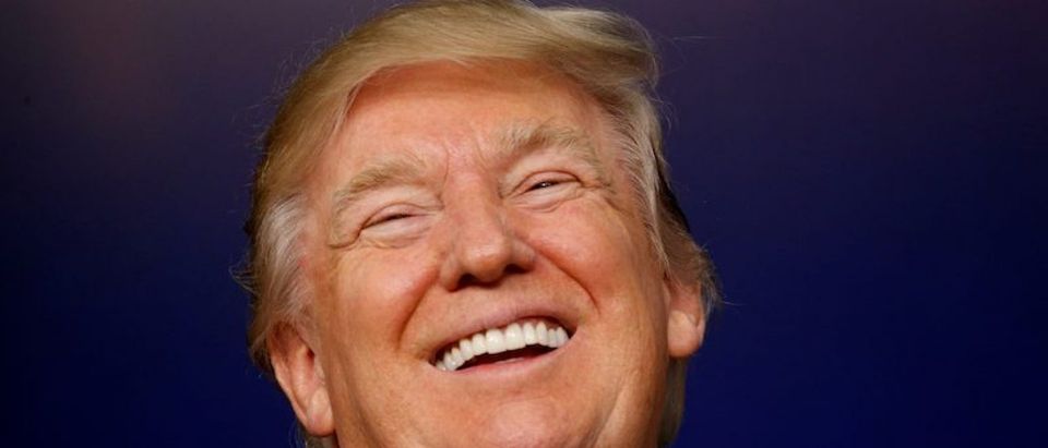 U.S. President Donald Trump laughs while hosting a CEO town hall on the American business climate at the Eisenhower Executive Office Building in Washington, U.S., April 4, 2017. REUTERS/Kevin Lamarque - RTX341QY