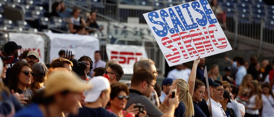 A Republican supporter holds up a sign supporting House Majority Whip Scalise (R-LA) before the Democrats and Republicans face off in the annual Congressional Baseball Game in Washington