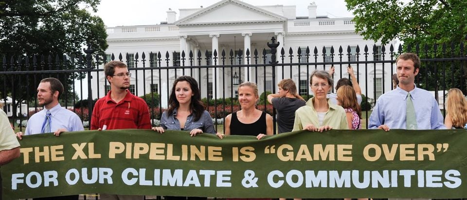 Protesters of the Keystone XL Pipeline hold a banner in front of the White House before the sixth day of arrests on August 25, 2011 in Washington. (Shutterstock/Rena Schild)
