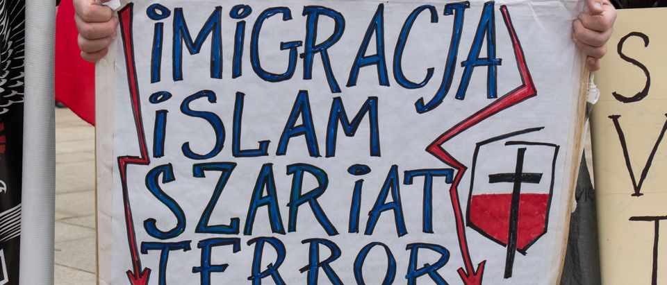 Shutterstock/ WARSAW, POLAND - FEBRUARY 06, 2016: Islam, sharia, terror, unidentified people during demonstration against refugees in Warsaw, Poland. Shutterstock/ Tomasz Bidermann