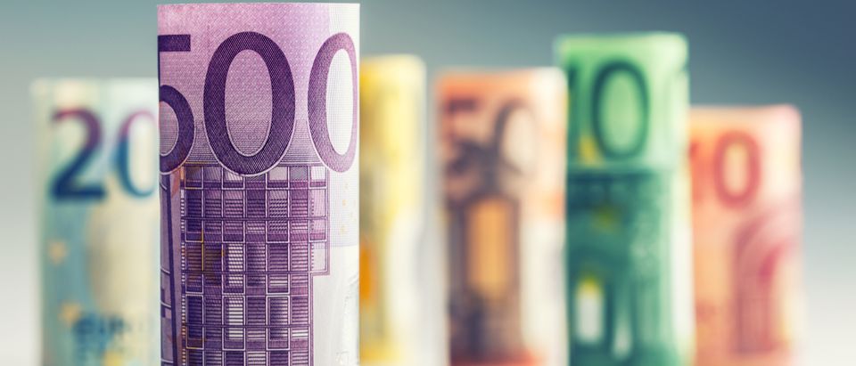 Several hundred euro banknotes stacked by value. (Shutterstock/ Marian Weyo)