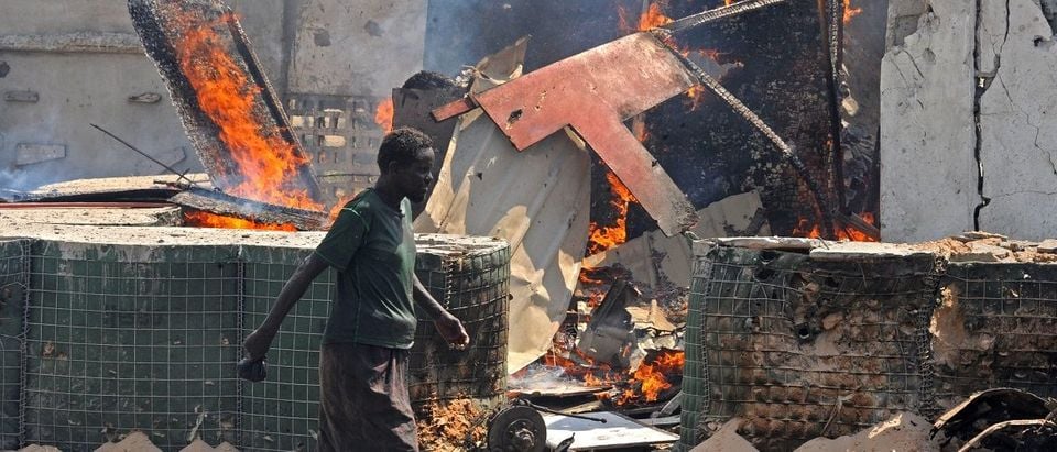 A man walks past the scene of a suicide attack in the Somali capital Mogadishu on July 31, 2016.