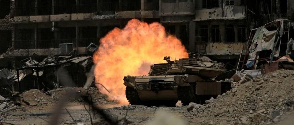 A tank of the Emergency Response Division fires at Islamic State militant in the old city of Mosul