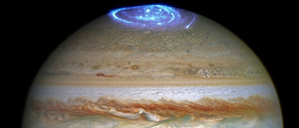 Auroras created by high-energy particles are seen on a pole of the planet Jupiter in a NASA composite image