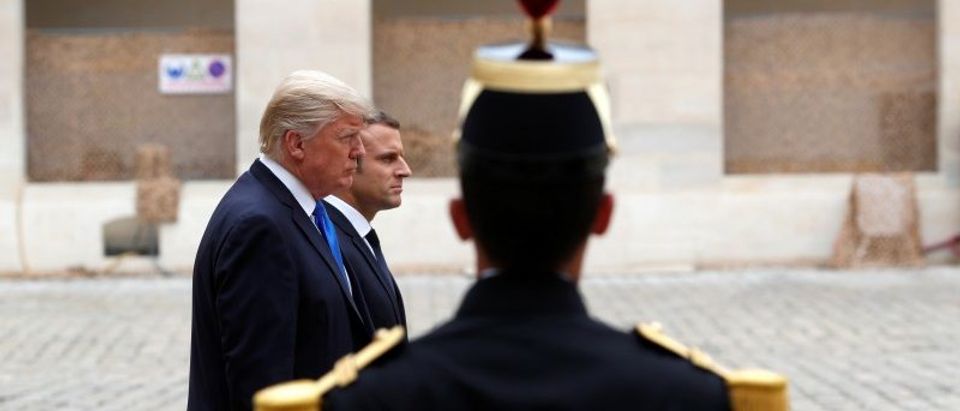 French President Emmanuel Macron and US President Donald Trump review troops during a welcoming ceremony at the Invalides in Paris