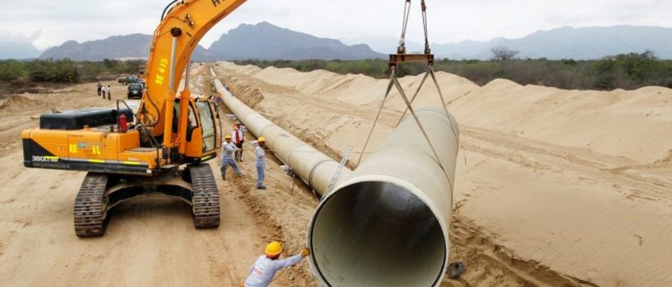 FILE PHOTO: Workers prepare a pipeline during the construction of the Olmos Irrigation Project in Lambayeque