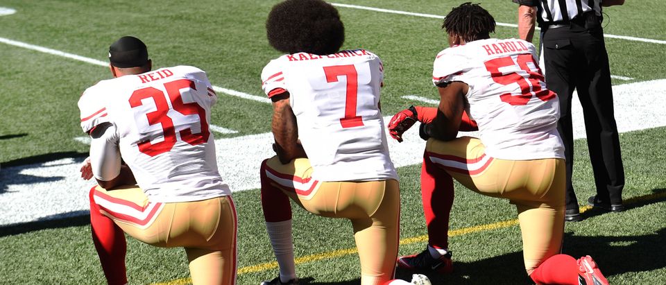 SEATTLE, WA - SEPTEMBER 25: (L-R) fFee safety Eric Reid #35, quarterback Colin Kaepernick #7 and outside linebacker Eli Harold #58 of the San Francisco 49ers kneel on the sidelines during the national anthem before the game against the Seattle Seahawks at CenturyLink Field on September 25, 2016 in Seattle,Washington. (Photo by Steve Dykes/Getty Images)