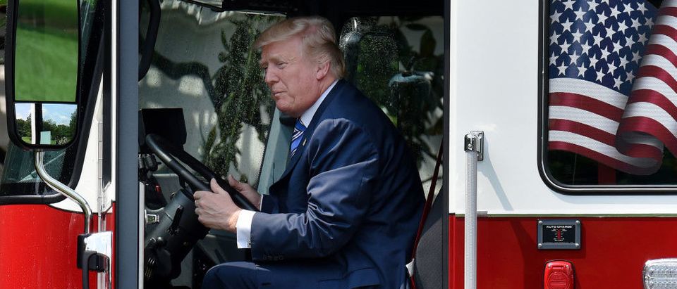 President Donald Trump examines a fire truck from Wisconsin-based manufacturer Pierce during a "Made in America" product showcase event on the South Lawn at the White House in Washington, DC, on July 17, 2017. OLIVIER DOULIERY/AFP/Getty Images