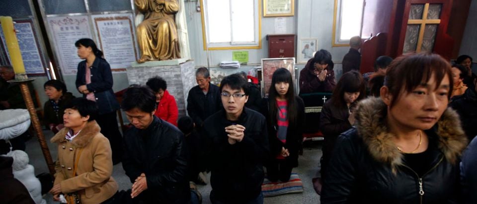 Believers take part in a weekend mass at an underground Catholic church in Tianjin