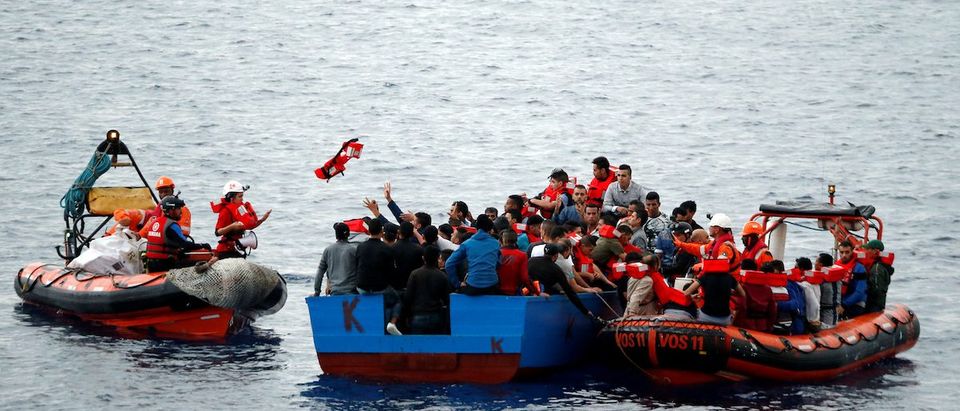 Migrants on a wooden boat are rescued by "Save the Children" NGO crew from the ship Vos Hestia in the Mediterranean sea off Libya coast