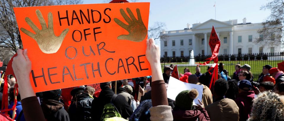 Protesters demonstrate against U.S. President Donald Trump and his plans to end Obamacare outside the White House in Washington, U.S., March 23, 2017. (Photo: REUTERS/Kevin Lamarque - RTX32FLD)