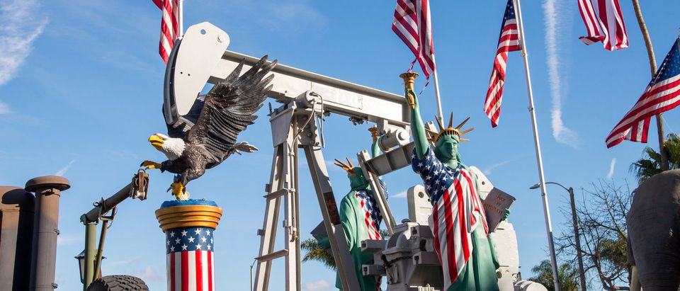 Huntington Beach, California - January 24, 2017. Oil field workers celebrate Donald Trumps victory and partnership with the oil industry by decorating oil pumps with American Flags and statues. (Shutterstock/Steve Bruckmann)