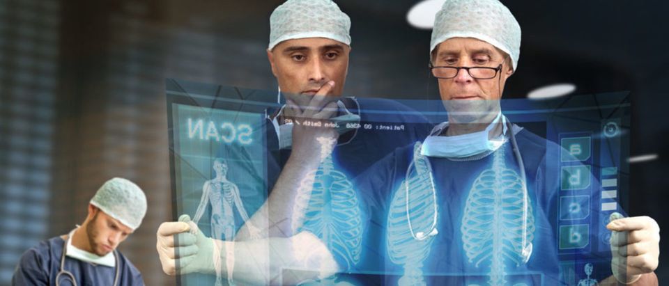 Doctors looking at a virtual medical screen. [Shutterstock - Luis Louro]