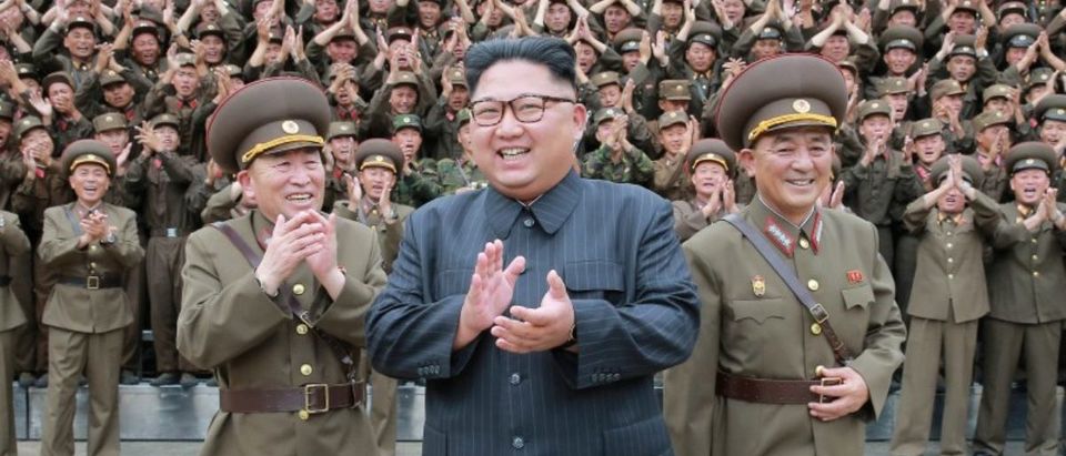 North Korean leader Kim Jong Un claps with military officers at the Command of the Strategic Force of the Korean People's Army (KPA) in an unknown location in North Korea