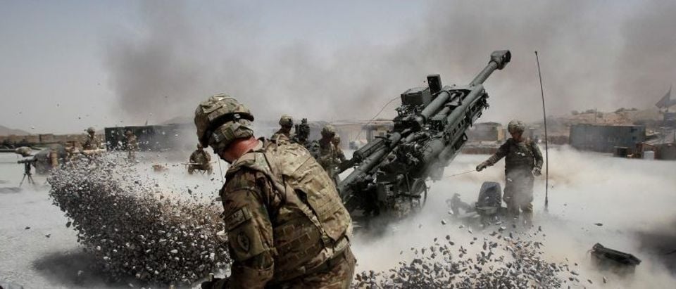 FILE PHOTO: U.S. Army soldiers from the 2nd Platoon, B battery 2-8 field artillery, fire a howitzer artillery piece at Seprwan Ghar forward fire base in Panjwai district