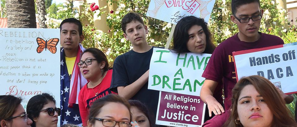 Children hold banners and placards while listening to speakers at a rally outside the 9th Circuit federal court in Pasadena, California on July 16, 2015, where Immigrant rights organizations, labor, and Deferred Action for Childhood Arrivals (DACA) recipients from Arizona and Los Angeles gathered. After a multiple-year legal battle, the state of Arizona's embattled efforts to deny driver's licenses to immigrants who have been granted DACA under a federal program will face what could be yet another blow to Arizona when the Court of Appeals for the Ninth Circuit hears oral arguments this Thursday in a lawsuit brought by civil rights groups challenging the discriminatory policy. PHOTO: Getty Images/AFP/FREDERIC J. BROWN
