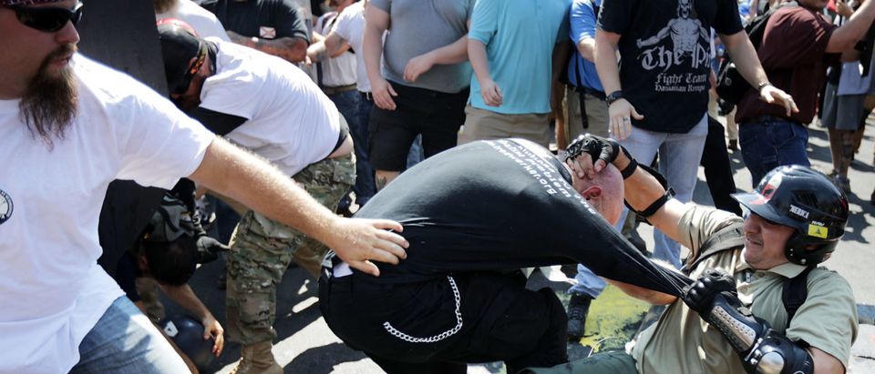 CHARLOTTESVILLE, VA - AUGUST 12: White nationalists, neo-Nazis and members of the "alt-right" clash with counter-protesters as they enter Lee Park during the "Unite the Right" rally August 12, 2017 in Charlottesville, Virginia. After clashes with anti-fascist protesters and police the rally was declared an unlawful gathering and people were forced out of Lee Park, where a statue of Confederate General Robert E. Lee is slated to be removed. (Photo by Chip Somodevilla/Getty Images)