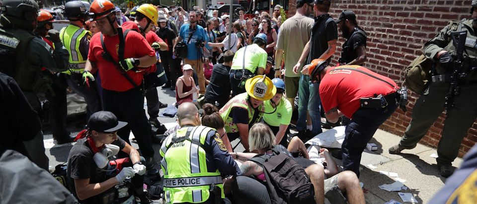 CHARLOTTESVILLE, VA - AUGUST 12: Rescue workers and medics tend to many people who were injured when a car plowed through a crowd of anti-facist counter-demonstrators marching through the downtown shopping district August 12, 2017 in Charlottesville, Virginia. The car plowed through the crowed following the shutdown of the "Unite the Right" rally by police after white nationalists, neo-Nazis and members of the "alt-right" and counter-protesters clashed near Lee Park, where a statue of Confederate General Robert E. Lee is slated to be removed. (Photo by Chip Somodevilla/Getty Images)