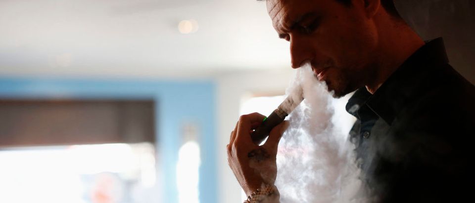 Enthusiast Damien Hoops uses an electronic cigarette at The Vapor Spot vapor bar in Los Angeles, California March 4, 2014. REUTERS/Mario Anzuoni