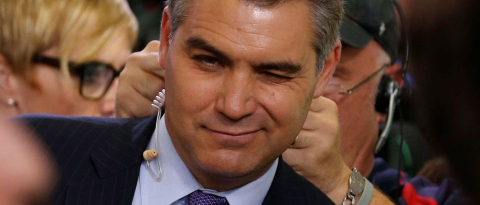 Acosta winks at a fellow reporter after the daily press briefing at the White House in Washington