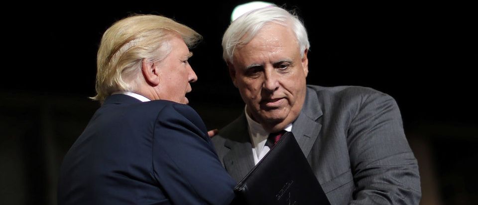 U.S. President Donald Trump talks with West Virginia's Democratic Governor Jim Justice after he announced that he is changing parties during a rally in Huntington, West Virginia U.S.