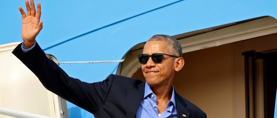 If you can't beat them, join them. Barack Obama joined the viral "thanks Obama" craze of his critics and filmed himself trying to dunk a cookie too big for his glass of milk while muttering, "thanks Obama" (REUTERS/Kevin Lamarque)