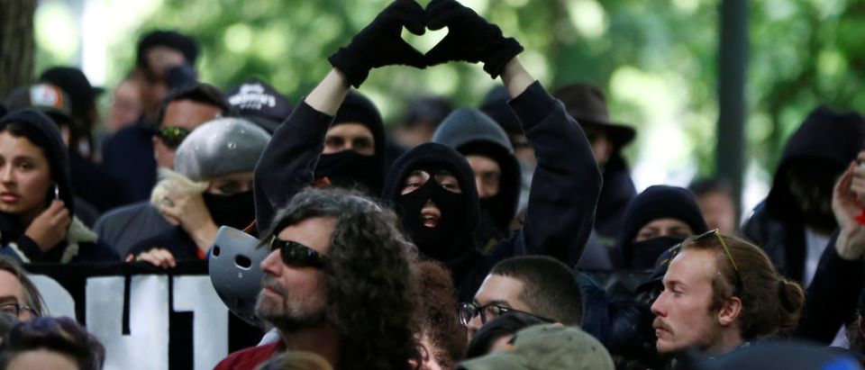An anti-facist protester makes the heart symbol during competing demonstrations in Portland, Oregon, U.S. June 4, 2017. REUTERS/Jim Urquhart