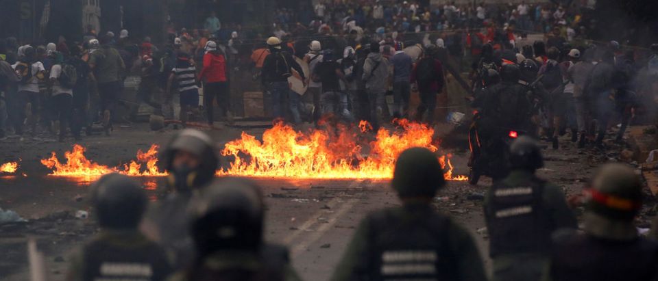 Demonstrators clash with riot security forces while rallying against Venezuela's President Nicolas Maduro's government in Caracas