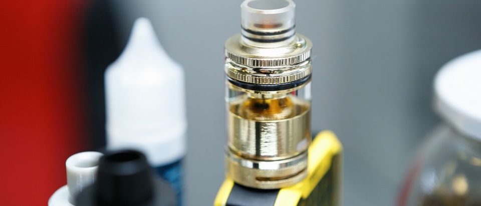 Vape shop.Modern vaping device maintenance & upgrade parts in close up. Buy popular ecig vaper device. Electronic cigarette gadget for smoking ejuice. Focus on dripper head with wire. (Shutterstock/hurricanehank)