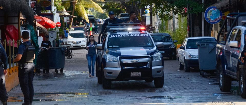 Mexican police agents patrol near a nightclub in Playa del Carmen, Quintana Roo state, Mexico where 5 people were killed, three of them foreigners, during a music festival on January 16, 2017. A shooting erupted at an electronic music festival in the Mexican resort of Playa del Carmen early Monday, leaving at least five people dead and sparking a stampede, the mayor said. Fifteen people were injured, some in the stampede, after at least one shooter opened fire before dawn at the Blue Parrot nightclub during the BPM festival. (PHOTO: STR/AFP/Getty Images)