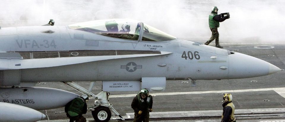 U.S. Navy crew members prepare for a F-18 Super Hornet's launch on the flight deck of the U.S. Navy carrier USS Abraham Lincoln off Ulsan