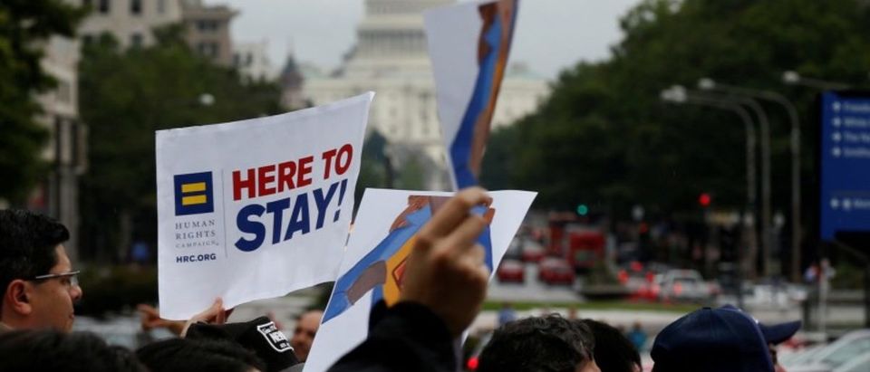 FILE PHOTO: Demonstrators carrying signs supporting immigrants march during a rally by immigration activists CASA and United We Dream demanding the Trump administration protect the Deferred Action for Childhood Arrivals (DACA) program and the Temporary Protection Status (TPS) programs, in Washington, U.S., August 15, 2017. REUTERS/Joshua Roberts