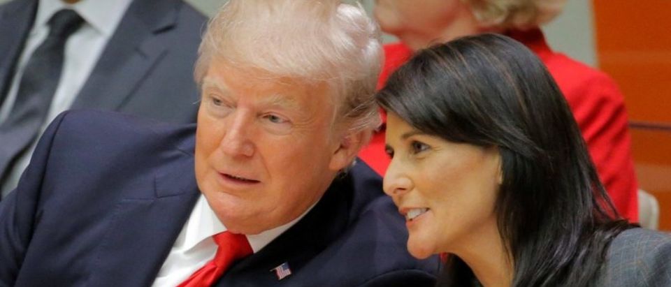 U.S. President Trump talks with U.S. Ambassador to the U.N. Haley as they attend a session at UN Headquarters in New York