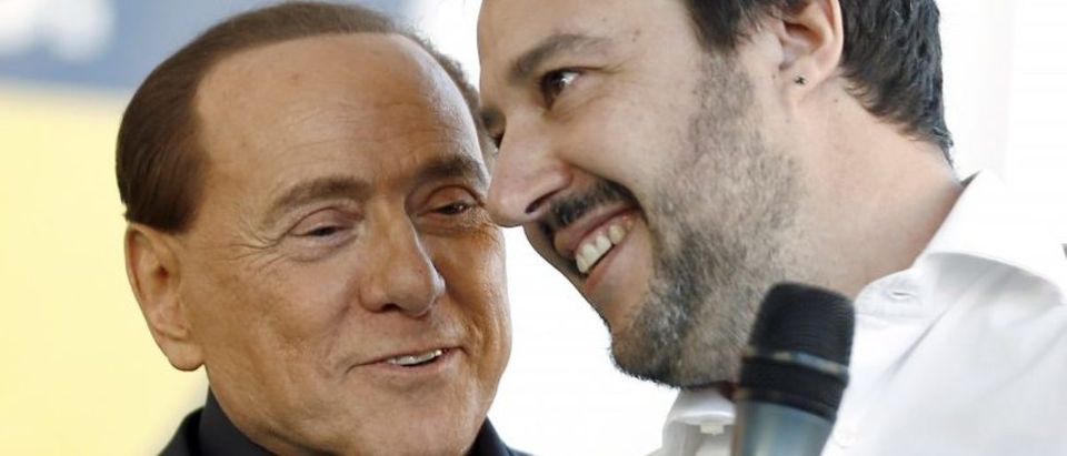 Forza Italia party (PDL) leader Berlusconi talks with Northern League leader Salvini during a rally in Bologna