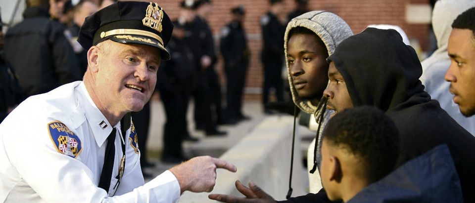 Captain Erik Pecha of the Baltimore Police Department chats with demonstrators in front of the Baltimore Police Department Western District station during a protest against the death in police custody of Freddie Gray in Baltimore April 23, 2015. (Sait Serkan Gurbuz/Reuters)