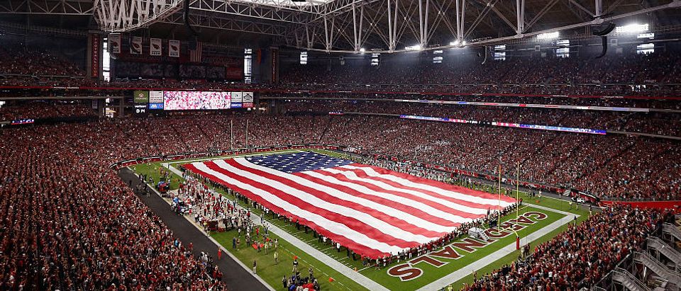 GLENDALE, AZ - SEPTEMBER 11: The American flag is draped across the field for the national anthem to the NFL game between the Arizona Cardinals and the New England Patriots at the University of Phoenix Stadium on September 11, 2016 in Glendale, Arizona. (Photo by Christian Petersen/Getty Images)