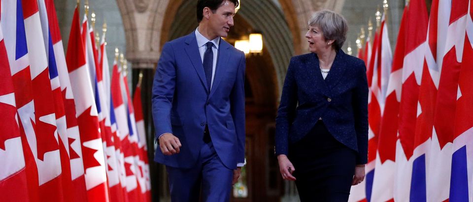 Canada's PM Trudeau and Britain's PM May walk in the Hall of Honour on Parliament Hill in Ottawa