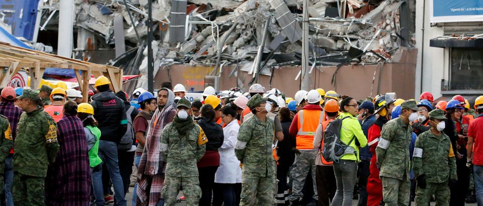 Soldiers and rescue team wait along the street after a tremor was felt in Mexico City