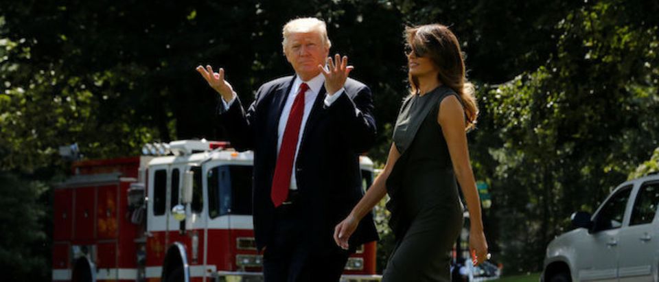 U.S. President Donald Trump signals to reporters that he can't hear their questions over the helicopter engines as he and first lady Melania Trump depart for a weekend retreat with his cabinet at Camp David, from the White House in Washington, U.S., September 8, 2017. REUTERS/Jonathan Ernst