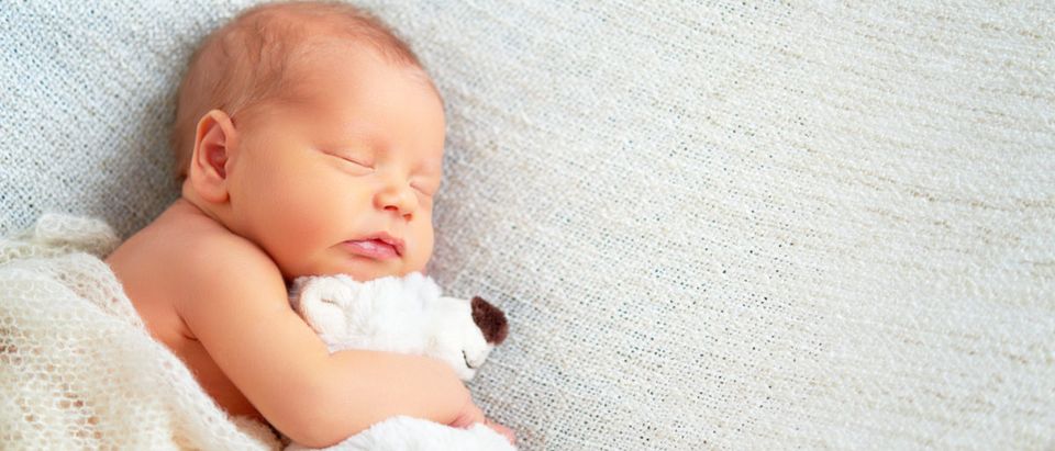 Shutterstock/ Cute newborn baby sleeps with a toy teddy bear Shutterstock/ Evgeny Atamanenko