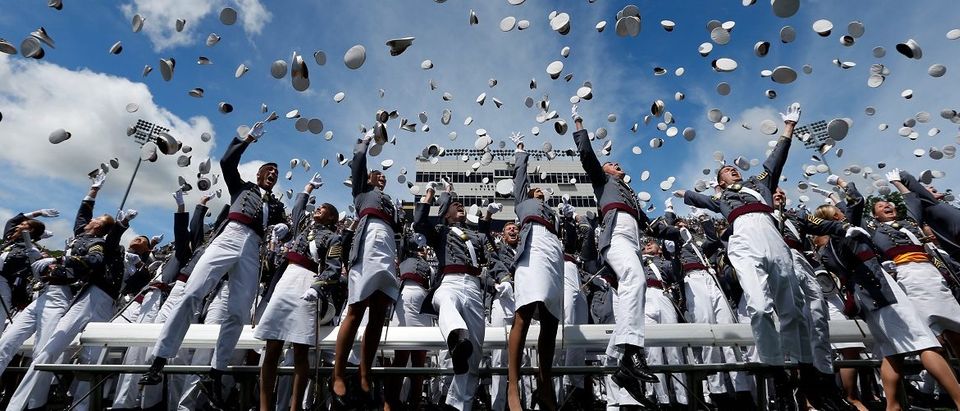 Graduates of the United States Military Academy toss their hats into the air at the conclusion of commencement ceremonies in West Point