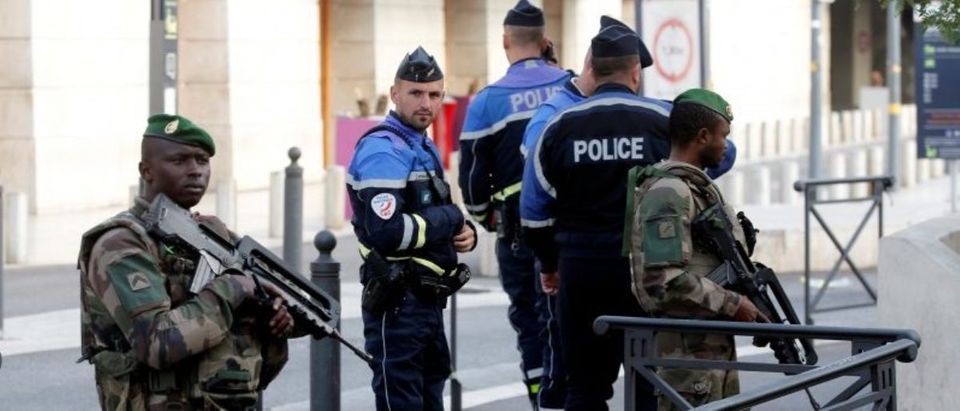 French police and soldiers secure a street near the Saint-Charles train station after French soldiers shot and killed a man who stabbed two women to death at the main train station in Marseille