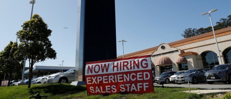 A now hiring sign is seen outside Lexus of Serramonte in Colma, California